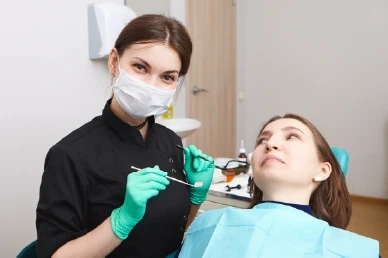 Initial consultation for periodontal treatment at Amazing Family Dental, where a dentist assesses gum health and discusses treatment options.