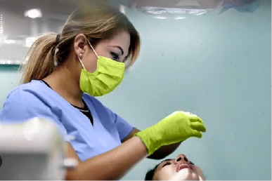 Fitting the permanent dental crown at Amazing Family Dental, ensuring comfort and proper alignment before final cementation.